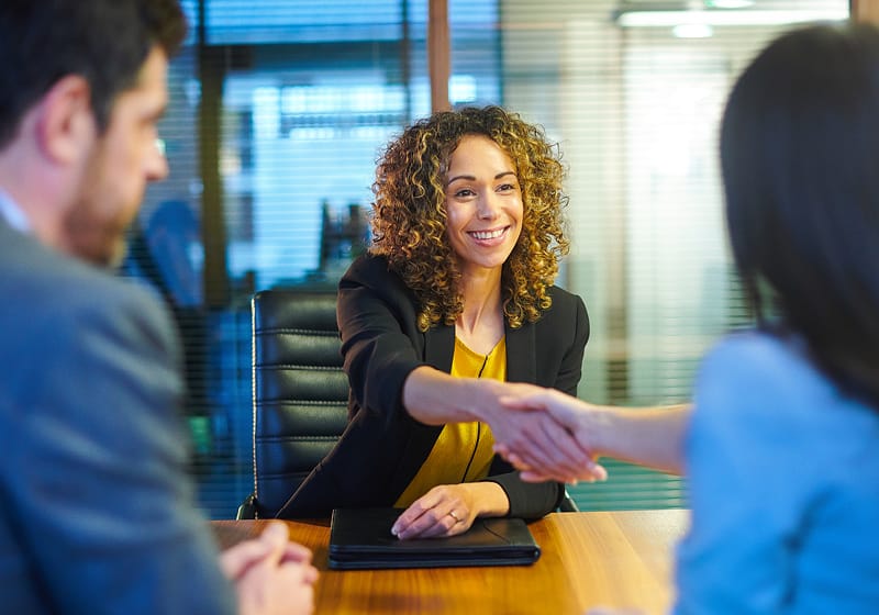 Woman shaking hands with another person